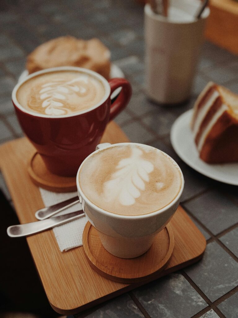 Two Cups of Brown Coffee on Top of Brown Tray